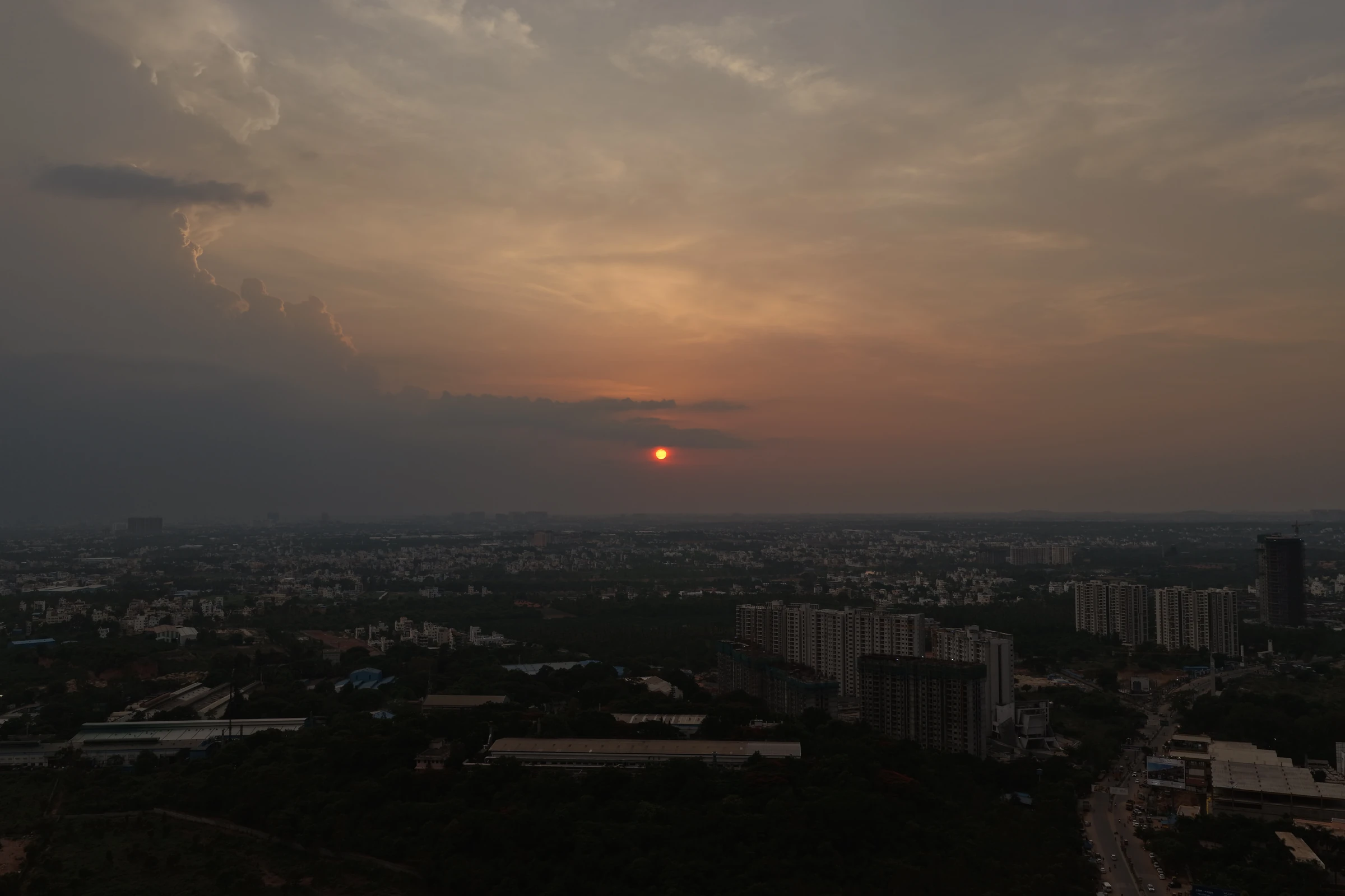 Sun setting over the city, an original aerial photograph by Mamathesh Gowda